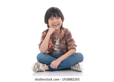 Happy Asian Boy Sitting On White Background Isolated