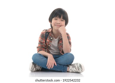 Happy Asian Boy Sitting On White Background Isolated