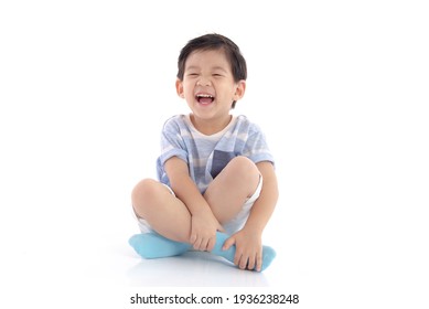 Happy Asian Boy Sitting On White Background Isolated