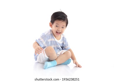 Happy asian boy sitting on white background isolated - Powered by Shutterstock