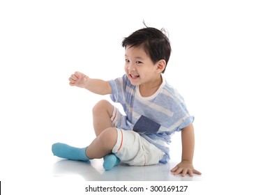 Happy Asian Boy Sitting On White Background Isolated