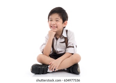 Happy Asian Boy Sitting On White Background Isolated