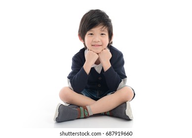 Happy Asian Boy Sitting On White Background Isolated