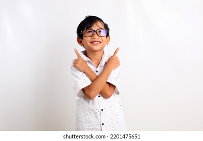 Happy Asian Boy Standing While Pointing Up With Both Hand. Isolated On White Background