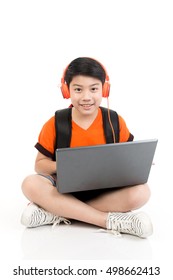 Happy Asian Boy Using Laptop On White Background .