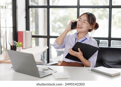 Happy asian business woman call centre representative customer support agent talking to client, smiling asian female working using laptop computer in office. - Powered by Shutterstock