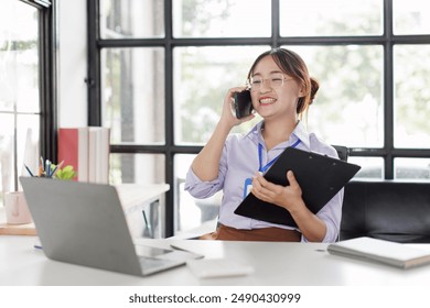 Happy asian business woman call centre representative customer support agent talking to client, smiling asian female working using laptop computer in office. - Powered by Shutterstock