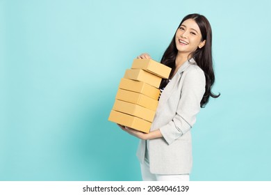 Happy Asian Business Woman Holding Package Parcel Box Isolated On Light Green Studio Background, Delivery Courier And Shipping Service Concept