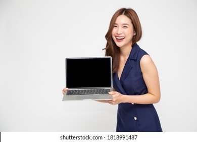 Happy Asian Business Woman Showing Blank Laptop Computer Screen Over White Background And Looking At Camera