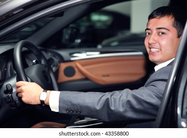 Happy Asian Businessman Driving A Luxurious Car
