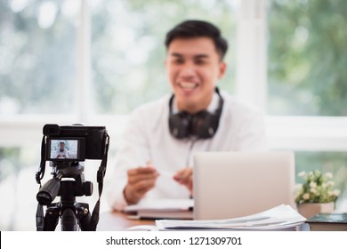 Happy Asian businessman videoblog / blogger vlogger recording online course or tutorial strategy presentation pass video for teaching live marketing sharing social media channel by mirrorless camera