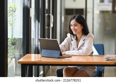 Happy Asian Businesswoman Reading Good News On Computer Tablet.