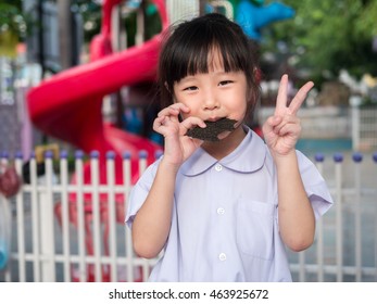 Happy Asian Child Eating Delicious Nori Seaweed