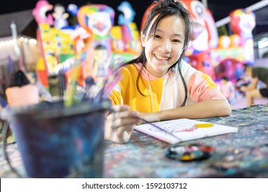 Happy Asian Child Girl Enjoy Paint Activities Having Fun,relax At Night,smiling Woman Using Watercolor With Palette And Paintbrush To Painting,study, Learn The Art,concept Development,hobby,activity 