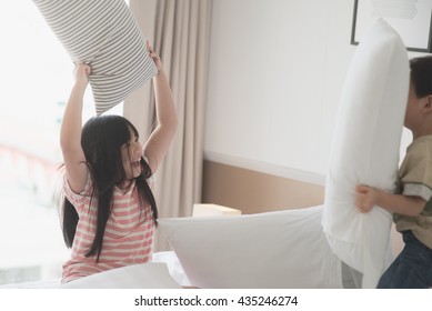 Happy Asian child having Pillow Fight in Hotel Room - Shutterstock ID 435246274
