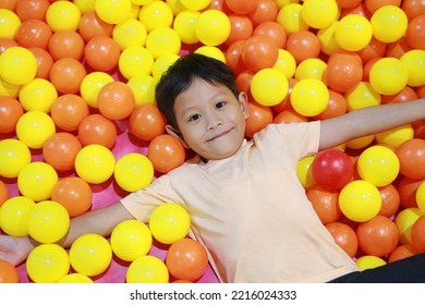 Happy Asian Child Playing At Colorful Plastic Balls Playground.