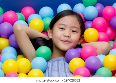 Happy Asian Child Playing At Kindergarten With Colorful Balls