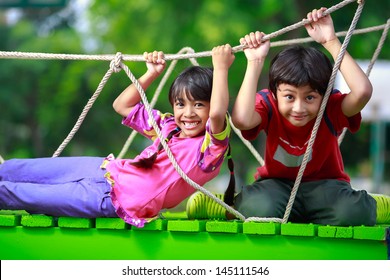 Happy asian child playing together on playground