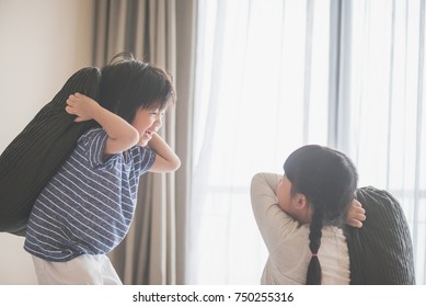 Happy Asian Child Ren Having Pillow Fight In Hotel Room