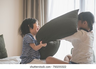 Happy Asian Child Ren Having Pillow Fight In Hotel Room