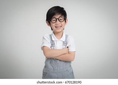 Happy Asian Child Wearing Eye Glasses Smiling On Gray Background