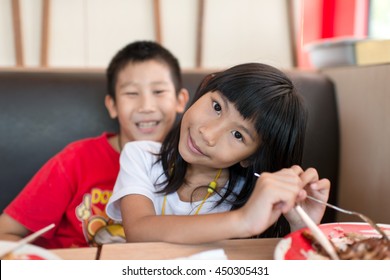 Happy Asian Children Eating Fast Food