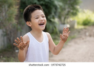 Happy Asian Children Playing Outside With Dirty Hands