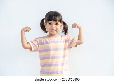 Happy Asian children showing her strong hands - Shutterstock ID 2031913805