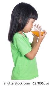 Happy Asian Chinese Little Girl Drinking Orange Juice In Isolated White Background