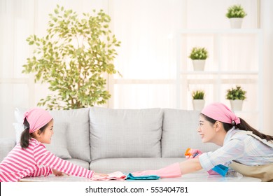 Happy Asian Chinese Mother And Kids Playing And Cleaning Living Room Together At Home Face To Each Other. Housework And Household Concept.