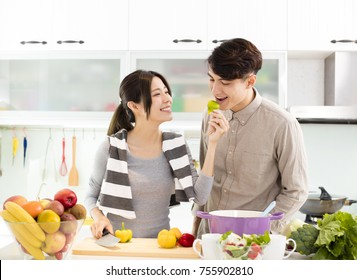 Happy Asian Couple Cooking In The Kitchen