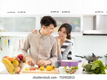 Happy Asian Couple Cooking In The Kitchen