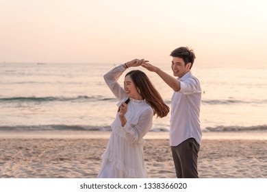 Happy Asian Couple Going Honeymoon Travel On Tropical Sand Beach In Summer