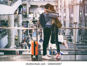  Happy Asian Couple Hugging Tight After A Long Separation. Romantic In Airport With Suitcases Are Ready For Traveling. 