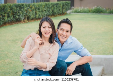 Happy Asian Couple In Love Smiling And Having Fun While Hugging Outdoor