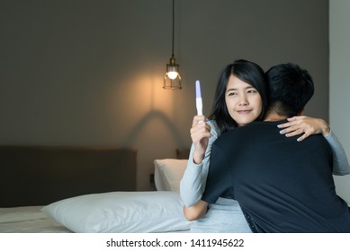 Happy Asian Couple Lover Smiling After Testing Pregnancy Test At Home,Fertility Treatment