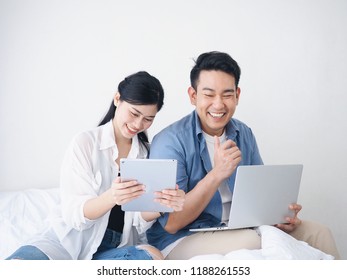 Happy Asian Couple Lover Using Laptop Together At Home.