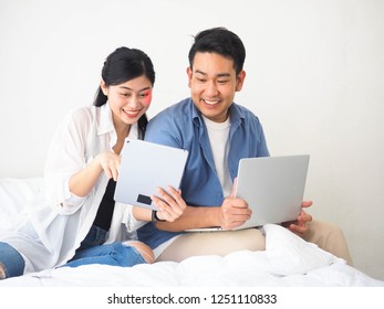 Happy Asian Couple Lover Using Laptop Together At Home.