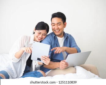 Happy Asian Couple Lover Using Laptop Together At Home.