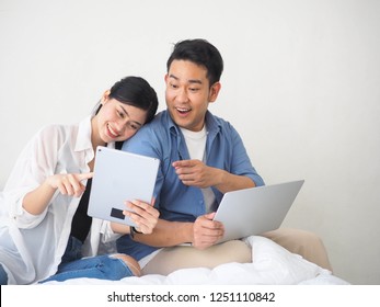 Happy Asian Couple Lover Using Laptop Together At Home.