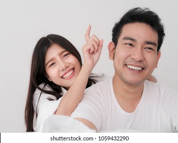 Happy Asian Couple On The Bed At Home, Lifestyle Concept.