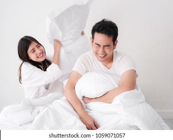 Happy Asian Couple Playing Pillow On Bed, Lover Lifestyle Concept