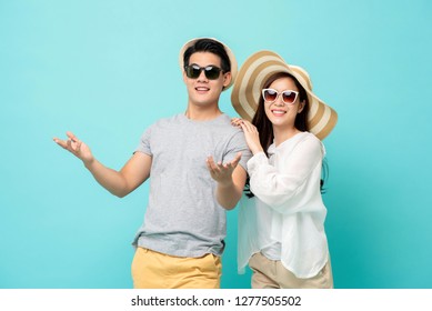 Happy Asian Couple In Summer Beach Casual Clothes Studio Shot Isolated On Light Blue Background