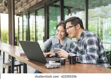 Happy Asian Couple Using Laptop Spending Time Together At Coffee Shop,family Concept.