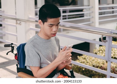 Happy Asian Disabled Teen Boy On Wheelchair Video Call To His Family While Isolation, Lifestyle In Education Of Disabled Kid, Remote Learning From Hospital Concept.