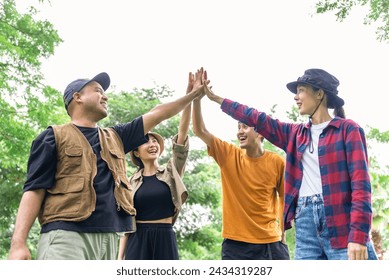 Happy asian diverse group friends enjoy and High five together. They feeling refreshing while camping in the nature. Recreation and journey outdoor activity lifestyle. - Powered by Shutterstock