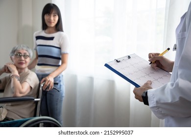 Happy Asian Doctor Showing Positive Cardiologist Graph Test Results To Senior Woman Patient With Daughter At Home, Healthcare And Medical In One Stop Service Concept