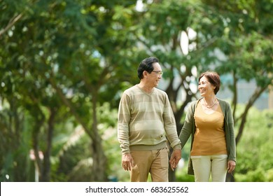 Happy Asian Elderly Couple Enjoying Date In City Park