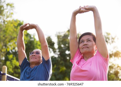 Happy Asian Elderly People Stretching Before Exercise At Park Outdoor.
