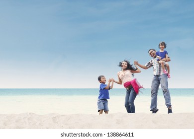 Happy Asian Family At The Beach